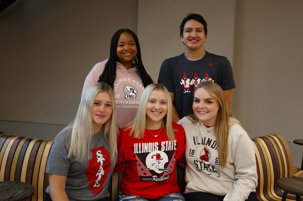 5 Illinois State students posing in Redbird apparel