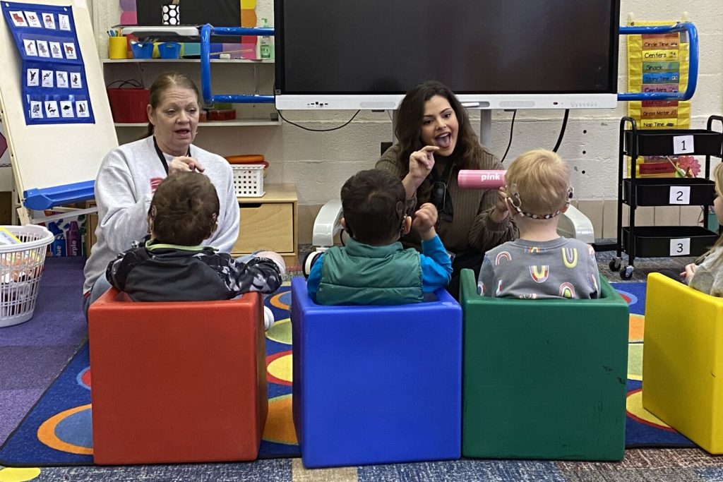 A special education teacher works with her students.