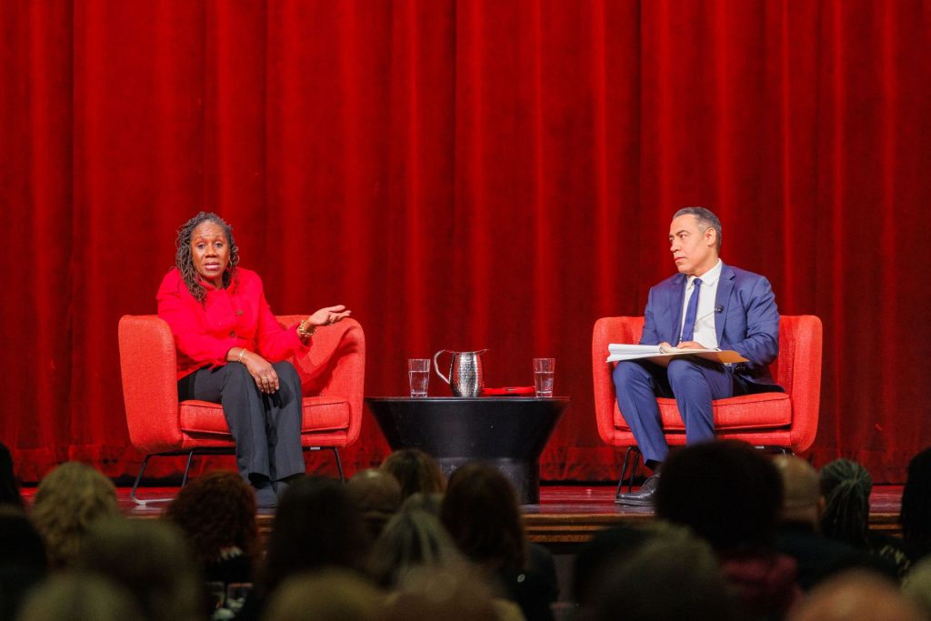 Dr. Touré Reed interviews Sherrilyn Ifill while seated on stage.