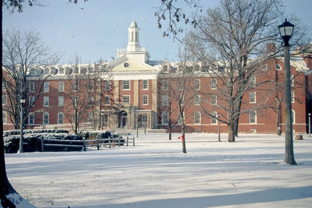 Fell Hall with snow on the Quad in an archived photo