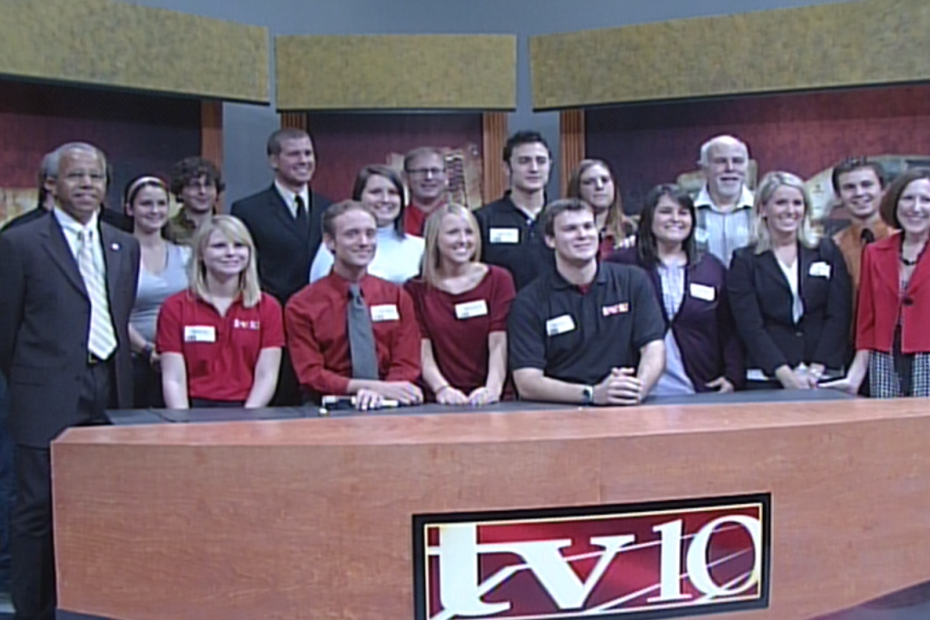 Group of students posing for a photo on the TV-10 set in 2008