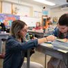 Thomas Metcalf educator helps a student with their work