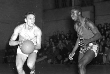 Black and white image of UCLA's Jackie Robinson, right, defending against an Illinois State University Normal (ISNU) player in a 1940 basketball game at McCormick Gymnasium.