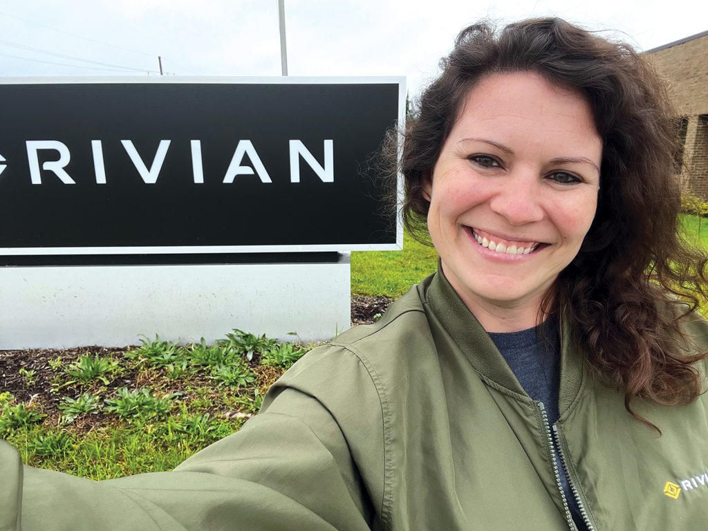 Sara Keene standing in front of Rivian signage
