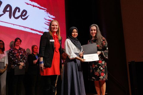 Sumaiya Hasan accepts the first-place award at the Three Minute Thesis competition from Dr. Ani Yazedjian, right, and Dr. Noelle Selkow, left.