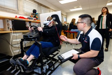 student and instructor using VR driving simulator