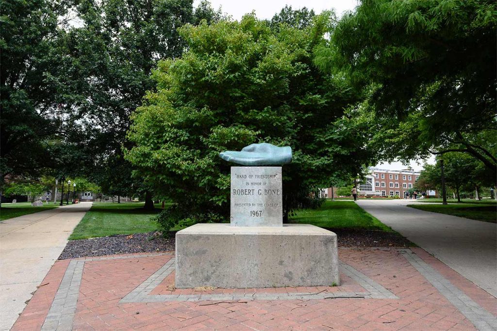 campus monument with open hand and text recognizing former president Robert G. Bone