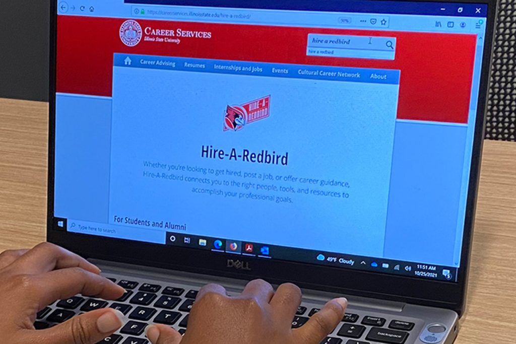 laptop screen displaying: Hire-A-Redbird Whether you're looking to get hired, post a job, or offer career guidance, Hire-A-Redbird connects you to the right people, tools, and resources to accomplish your professional goals.