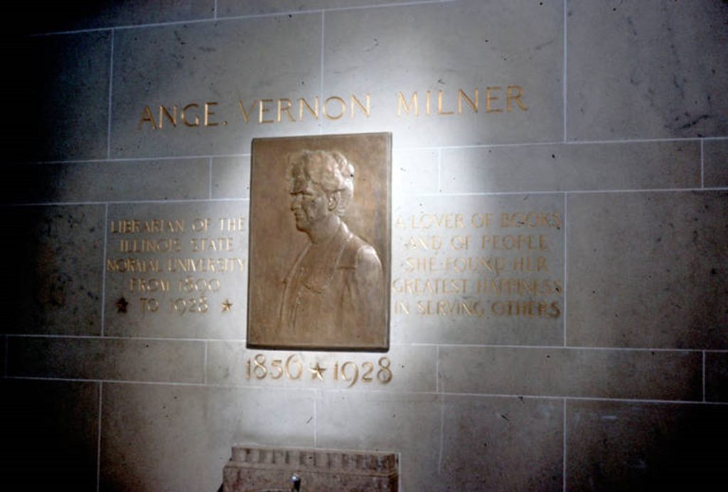 A color photo of a memorial to Ange Milner on the wall of Williams Hall. The inscription reads: “Librarian of the Illinois State Normal University” on the left side and “A lover of books and of people she found her greatest happiness in serving others” on the right with 1890-1928 underneath.