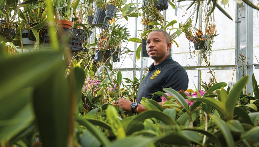 Dr. Theoneste “Theo” Nzaramyimana, M.S. ’17 in greenhouse
