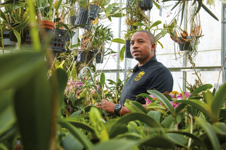 Dr. Theoneste “Theo” Nzaramyimana, M.S. ’17 in greenhouse