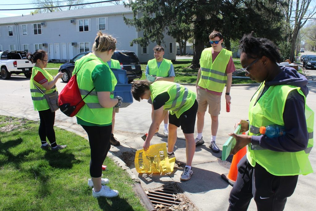 A group of students volunteer in drain stenciling during 2023's Bring It Back to Normal.
