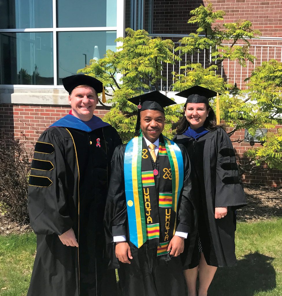 Dr. Theoneste “Theo” Nzaramyimana with Drs. David Kopsell and Aslihan Spaulding in graduation caps and gowns