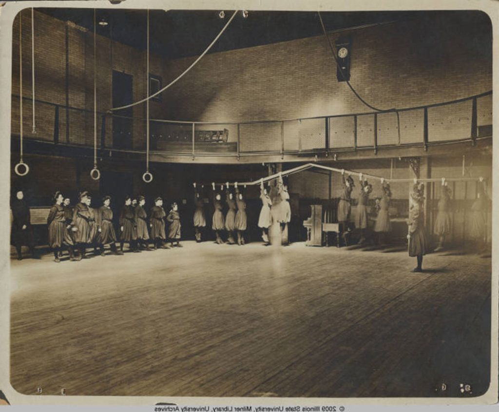 A sepia-toned photo of a 1906 physical education class at ISNU. 