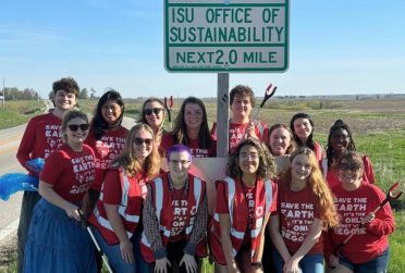 Group photo in front of sign with text "ISU Office of Sustainability"
