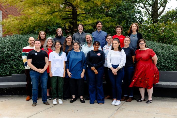 Women's, Gender, and Sexuality Studies faculty and staff attend the program's annual fall retreat, 2023. A group of people posed in front of trees and a bench outside of Stevenson Hall.