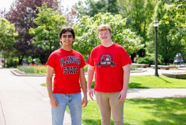 Two students standing next to each other on the Quad wearing Illinois State shirts