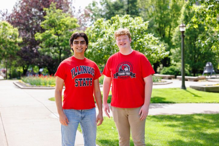 Two students standing next to each other on the Quad wearing Illinois State shirts