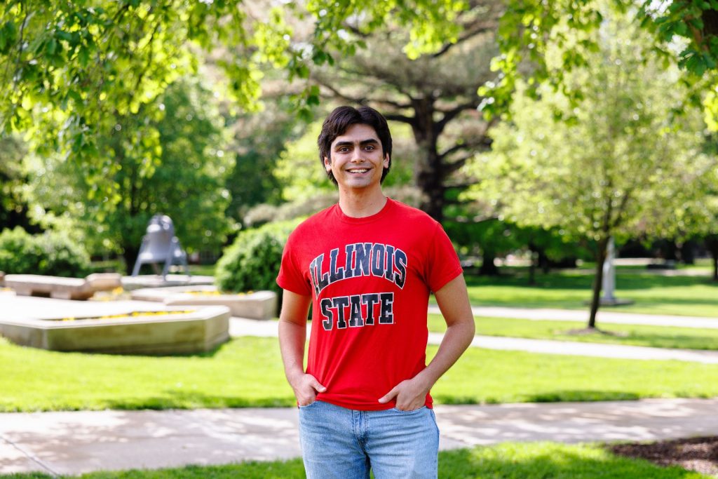 Student standing on the Quad wearing a red t-shirt