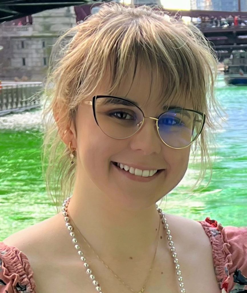 Amelia Korveziroska headshot with water in the background