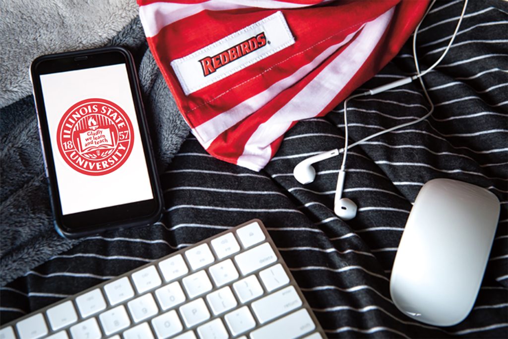 collage of phone screen, mouse, ear buds and keyboard, surrounded by Illinois State apparel