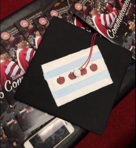 Ana Pyper's mortarboard. She designed it after the Chicago flag replacing the stars with teacher apples! 