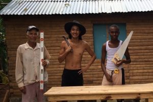 Michael Anstirman (center) with neighbors building a table for his house.