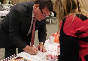 image of President Larry Dietz signing a SECA pledge form. 