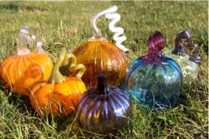 glass pumpkins from ISU Glasshouse, sitting on the grass