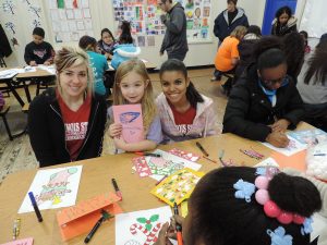 Illinois State University students create gifts with their Holiday Helper children.