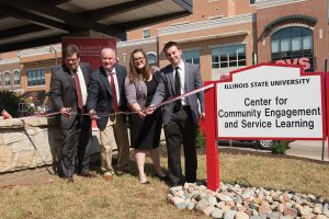 Four people cut ribbon for the Center for Community Engagement and Service Learning