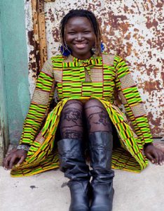 woman sitting o the street and smiling