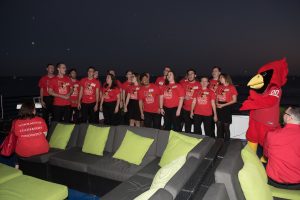 Madrigals singing group performing on top of the Mystic Blue at the Redbirds Rising Chicago campaign event. 