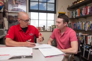 An Illinois State faculty member meets with a student—something you can take advantage of with your own college visit.