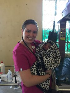 Abby Mustread, ISU Bone Scholar, holding a baby that she helped deliver in a rural hospital in Kenya. 