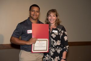 Tyler Bryant received the Student Access and Accommodation Services Educational Enhancement Scholarship from Sarah Metivier, coordinator of the text conversion lab at SAAS in October.