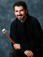 image of David Collier seated and holding percussion instrument