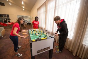 Students play foosball in residence hall