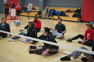 Paralympian Ashley Green shows ISU students how to play sitting volleyball.