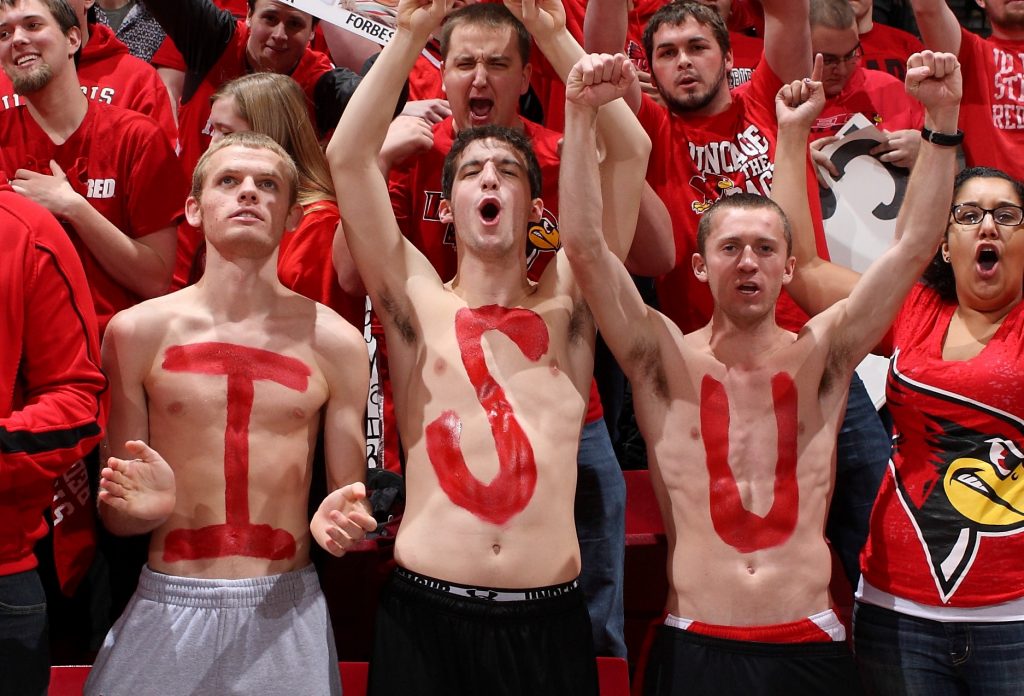 Student Redbird fans with their chests painted cheering