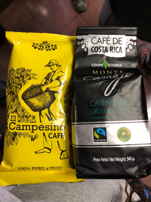 A yellow bag of "El Campesino Café" and a bag of "Café de Costa Rica fair trade coffee.