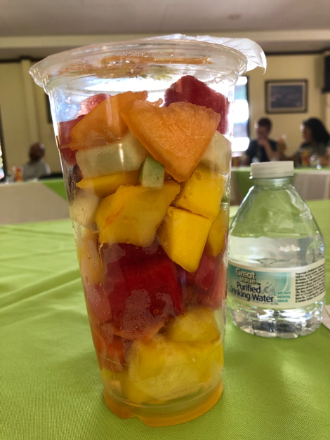 A fruit cup with watermelon, mango, pineapple, cantaloupe, melon, strawberries and papaya.
