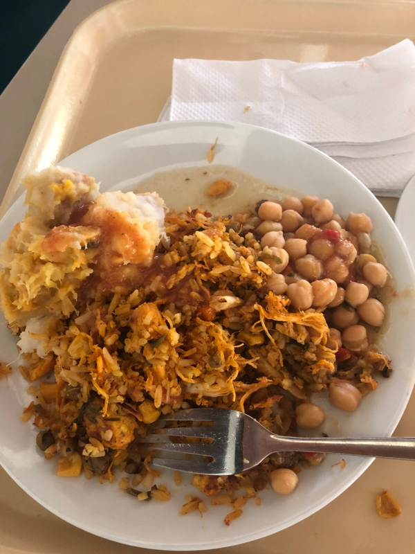 Lunch consisting of beans, rice, potatoes and chicken.