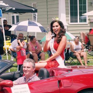 Miss Illinois Ariel Beverly being driven through the Fourth of July parade in her hometown of East Moline.