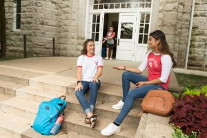 Students talking on the steps of Cook Hall