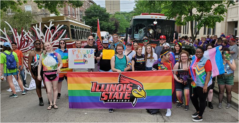 Peopel marching with a banner that reads Illinois State Redbirds