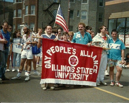 People marching with a banner that says Gay People's Alliance Illinois State University