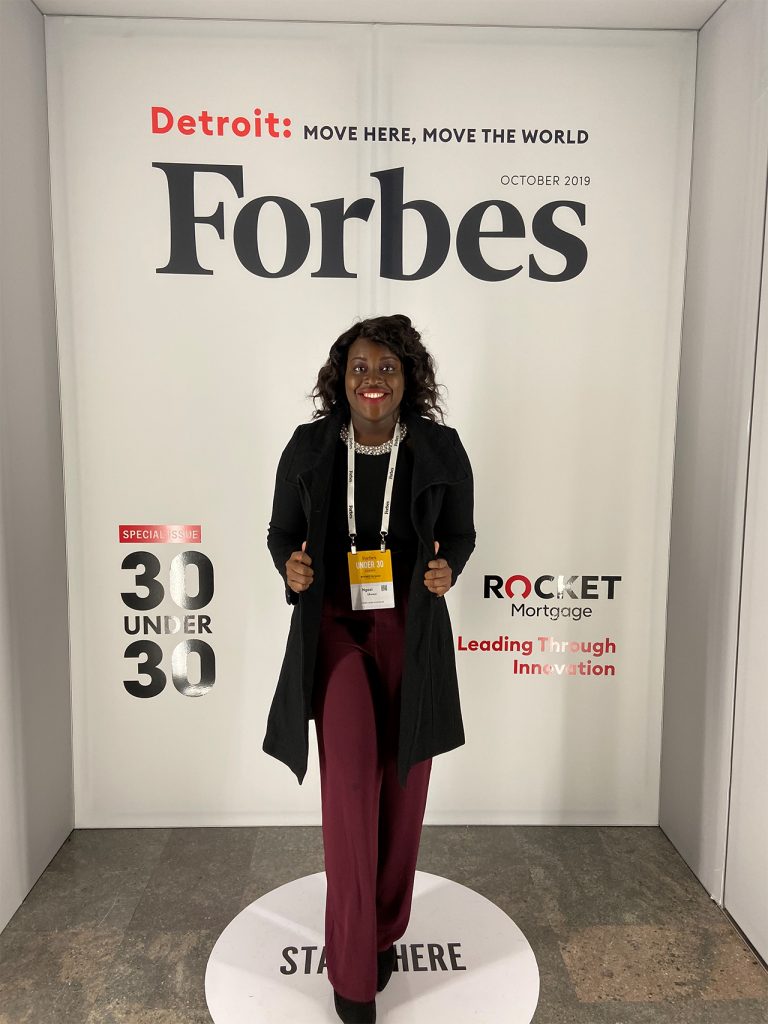 Ngozi Ukweni standing in front of a Forbes backdrop