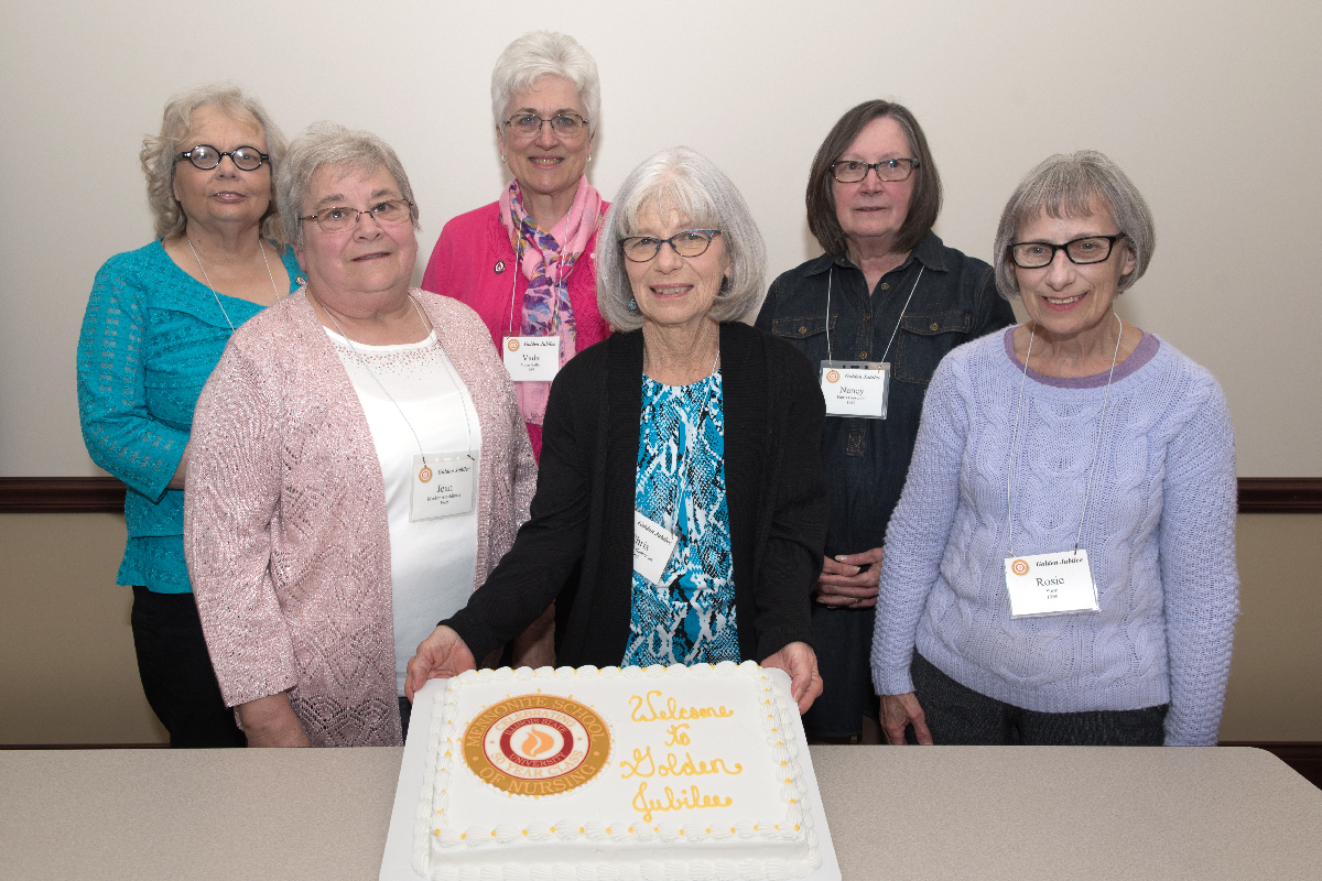 Golden Jubilee guests from the class of 1969 pose with a commemorative cake.