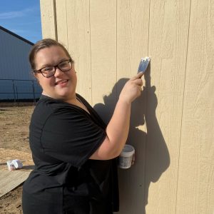 Woman scrapes building 